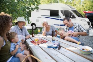Multi-generation family bonding at campsite picnic table